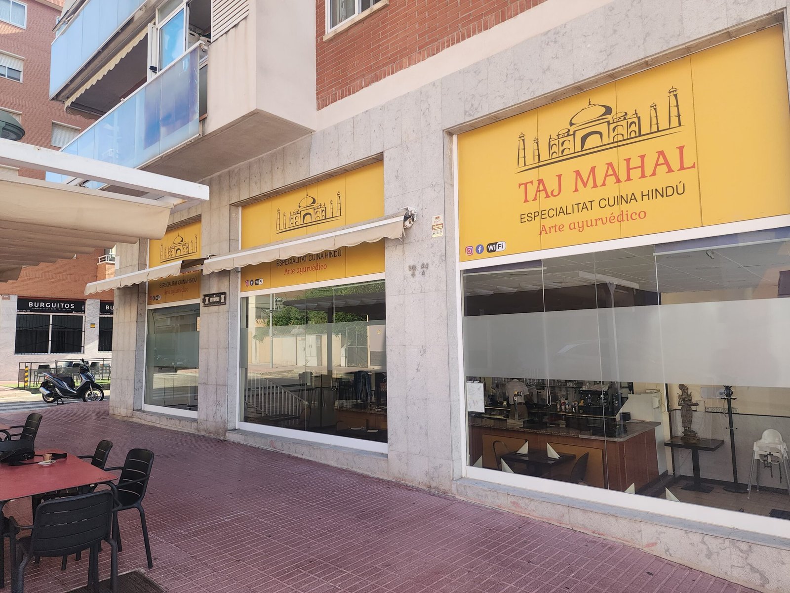 Fachada del restaurante Taj Mahal en Tarragona con su rótulo y la terraza